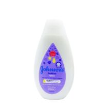 Johnson's Baby Bedtime Lotion 300ml bottle on a nursery shelf beside baby bath products