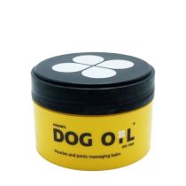 Masons Dog Oil Massaging Balm 100g tub on a wooden surface next to a dog
