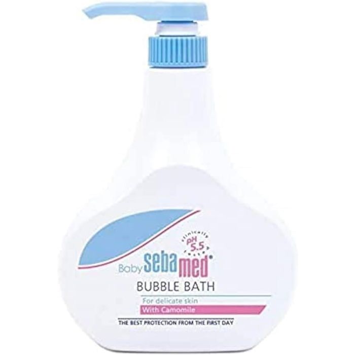 Sebamed Baby Bubble Bath Camomile 500ml bottle beside a baby bath with foam bubbles
